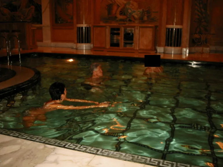 Clinton swims in a pool with Maxwell in this image released by the Department of Justice [Handout/US Justice Department via Reuters]